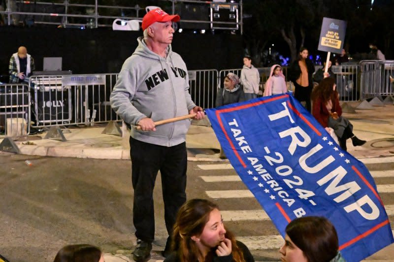 A man holds a Trump 2024 flag at a protest outside the office of Prime Minister Benjamin Netanyahu in Jerusalem, calling for the war against Hamas to continue until a decisive victory on Thursday. Photo by Debbie Hill/UPI