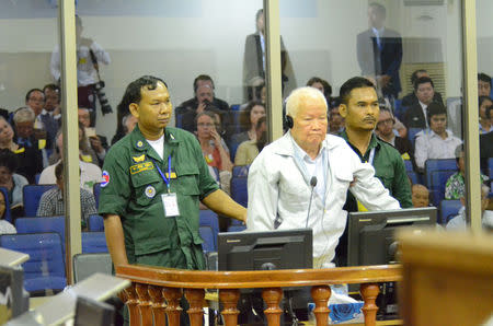 Former Khmer Rouge head of state Khieu Samphan stands inside a dock at the courtroom of the Extraordinary Chambers in the Courts of Cambodia (ECCC) as he awaits a verdict, on the outskirts of Phnom Penh, Cambodia, November 16, 2018. Extraordinary Chambers in the Courts of Cambodia (ECCC)/Handout via REUTERS