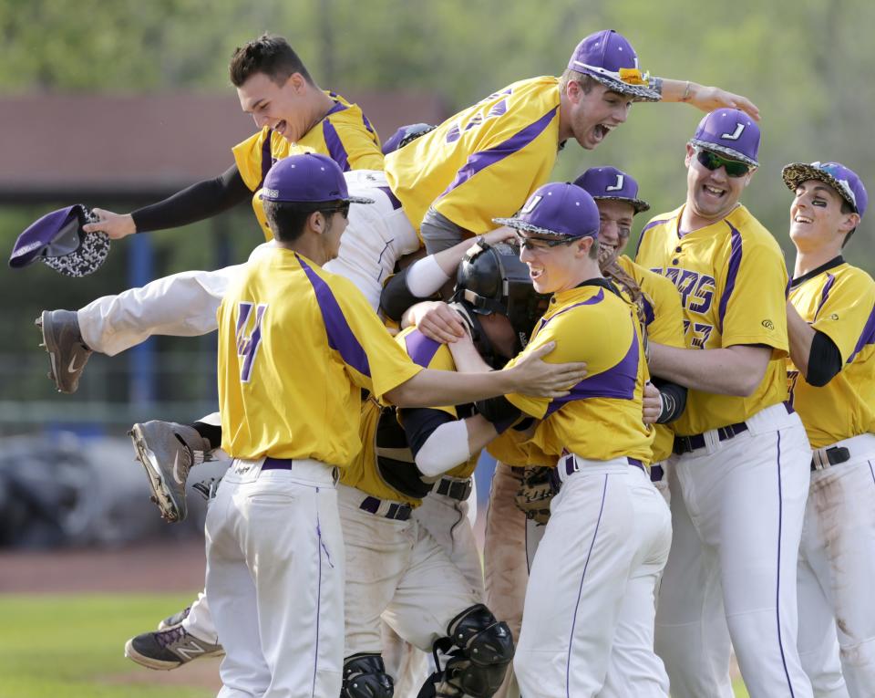 Jackson baseball players converge on pitcher Ryan Gusbar (front right) after the final out of the 2014 Division I district championship game at Thurman Munson Memorial Stadium.