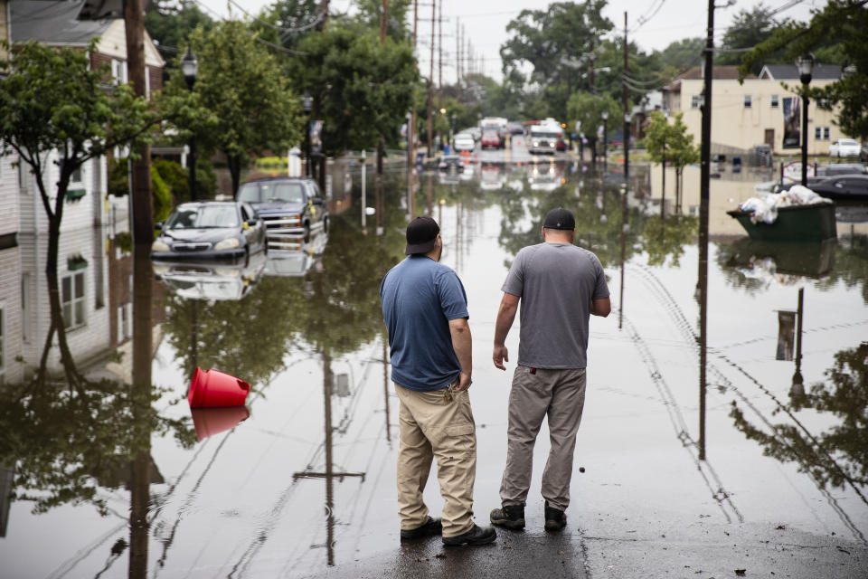 People inspect the floodwaters submerging Broadway in Westville, N.J. Thursday, June 20, 2019. Severe storms containing heavy rains and strong winds spurred flooding across southern New Jersey, disrupting travel and damaging some property. (Photo: Matt Rourke/AP)