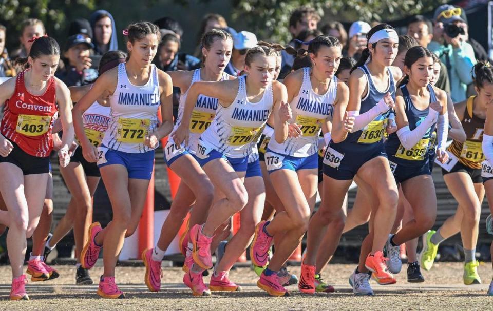 Members of the Immanuel girls cross country team start off on the course during the girls Division V state cross country championships at Woodward Park in Fresno on Saturday, Nov. 25, 2023.