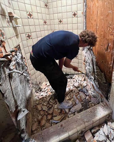 <p>Credit: Ant Anstead/Instagram</p> Ant Anstead shares photo of son Archie picking away at bathroom wall tile.