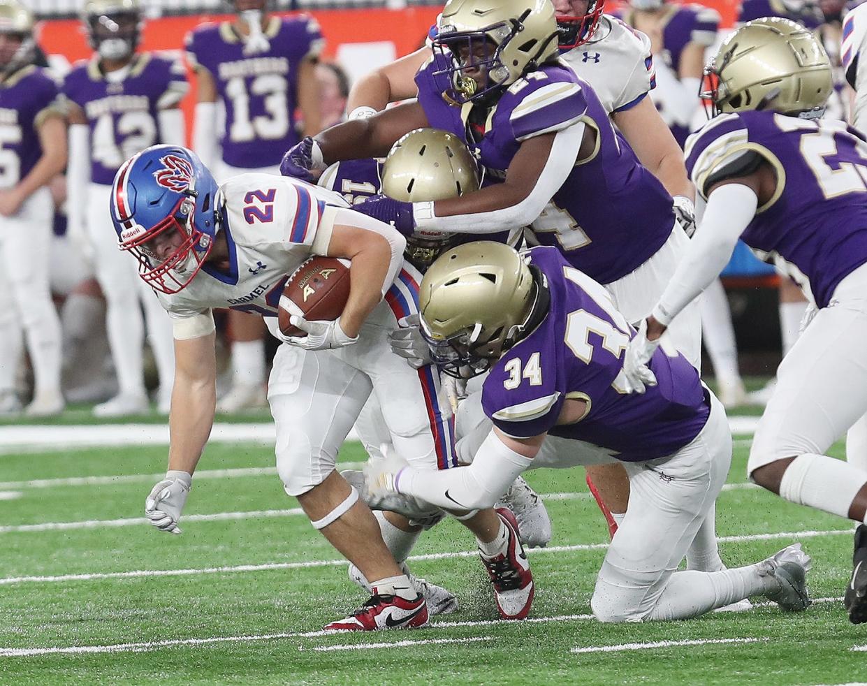 Carmel's Tristen Werlau (22) looks for some running room in the Christian Brothers Academy defense during the New York State Class AA championship at the JMA Dome in Syracuse Dec. 3, 2023.
