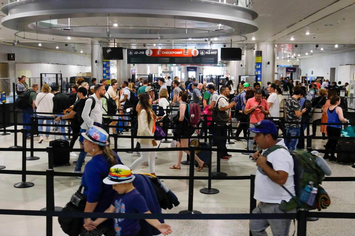 Passengers are seen waiting in line prior going to a checkpoint at Miami International Airport on Monday, Feb. 6, 2023.