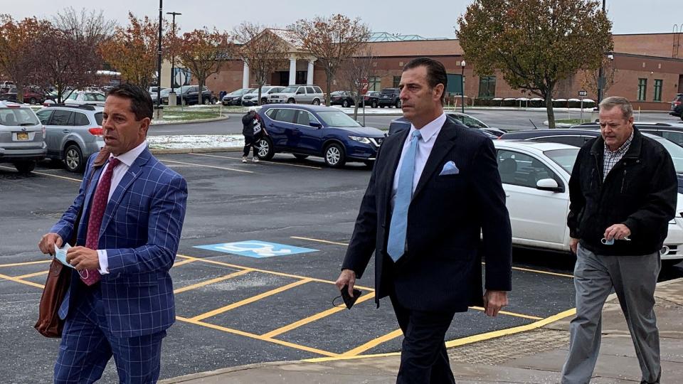 Former Greece police chief Andrew Forsythe, center, enters Greece Town Court with his attorney Steve Sercu on Dec. 9, 2021.