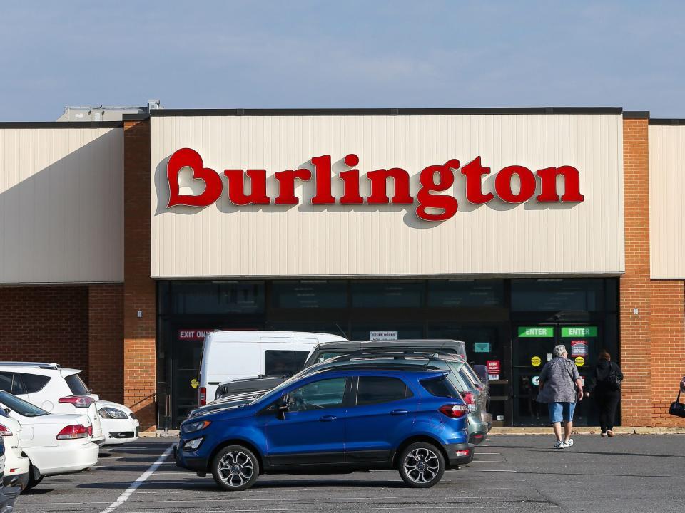 Exterior of Burlington store with customers walking out and cars parked in front