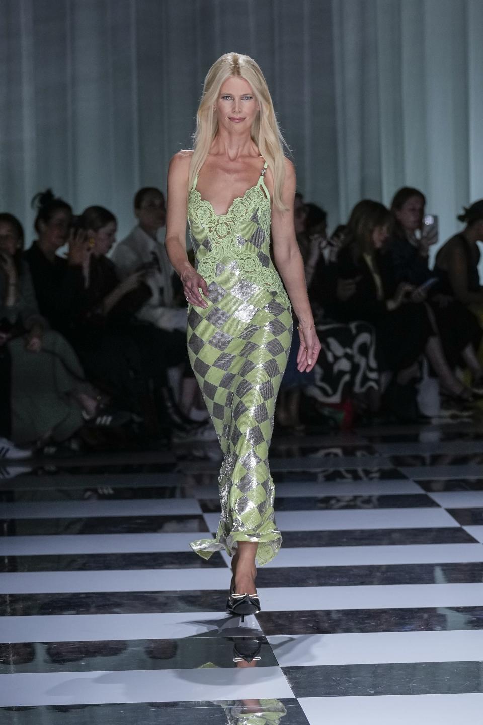 Claudia Schiffer wears a creation as part of the Versace women's Spring Summer 2024 collection presented in Milan, Italy, Friday, Sept. 22, 2023. (AP Photo/Antonio Calanni)