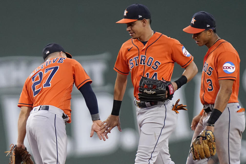 Houston Astros' Jose Altuve (27) celebrates with Mauricio Dubon (14) and Jeremy Pena (3) after the Astros defeated the Boston Red Sox in a baseball game Wednesday, Aug. 30, 2023, in Boston. (AP Photo/Steven Senne)