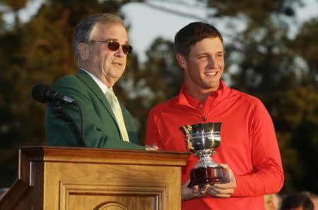 Apr 10, 2016; Augusta, GA, USA; Augusta National chairman Billy Payne (left) presents Bryson DeChambeau (right) with the low amateur award after the final round of the 2016 The Masters golf tournament at Augusta National Golf Club. Mandatory Credit: Rob Schumacher-USA TODAY Sports