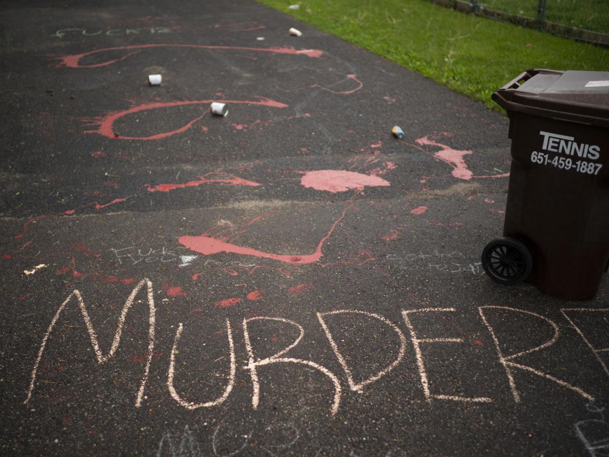 Splattered paint and chalk writing are on the driveway of the home of fired Minneapolis police Officer Derek Chauvin in Oakdale, Minn., Wednesday, May 27, 2020. The mayor of Minneapolis called Wednesday for criminal charges against Chauvin, the white police officer seen on video kneeling against the neck of Floyd George, a handcuffed black man who complained that he could not breathe and died in police custody. (Jeff Wheeler/Star Tribune via AP): Associated Press