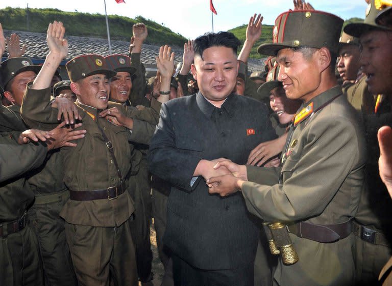 Image provided by the KCNA on June 4 shows North Korean leader Kim Jong-Un being greeted by soldiers in North Korea. North Korea may be just one or two months away from restarting a reactor to produce plutonium, potentially allowing the regime to ramp up its nuclear weapons program, a think tank said