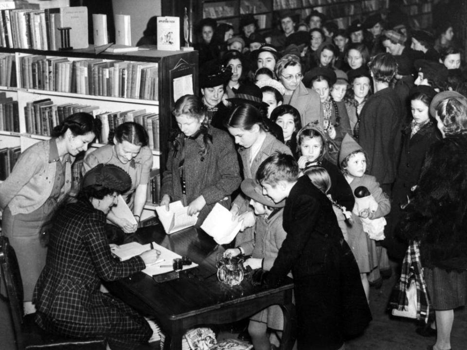 People queuing for the autograph of Enid Blyton at a store in Brompton on 2 January 1945 (Getty)