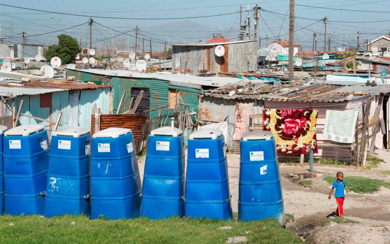 A row of portable toilets at an informal settlement in Khayelitsha, Cape Town - AFP