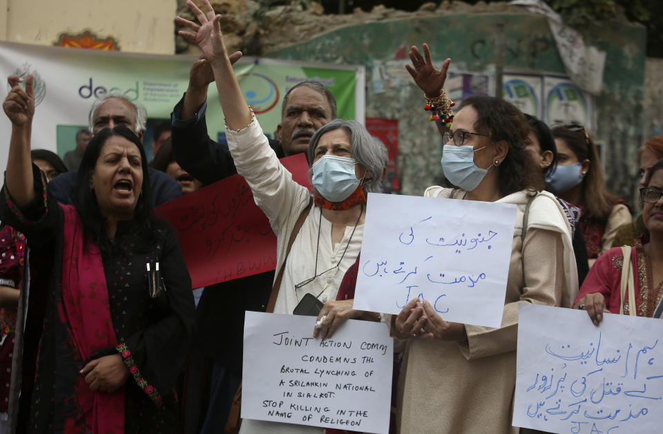 Members of a civil society group chant slogans during a demonstration to condemn Sialkot's lynching incident, in Lahore, Pakistan, Saturday, Dec. 4, 2021. Police arrested multiple suspects and detained dozens of others in the lynching of a Sri Lankan employee at a sports equipment factory in eastern Pakistan, officials said Saturday. (AP Photo/Fareed Khan)