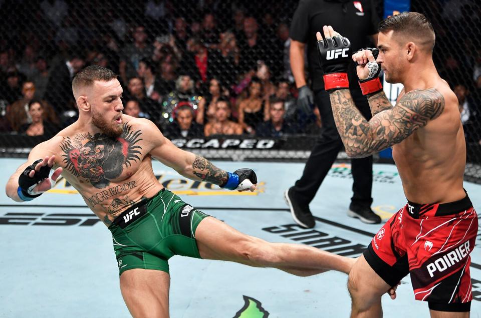Conor McGregor of Ireland kicks Dustin Poirier in their welterweight fight during the UFC 264 event at T-Mobile Arena on July 10, 2021 in Las Vegas, Nevada.