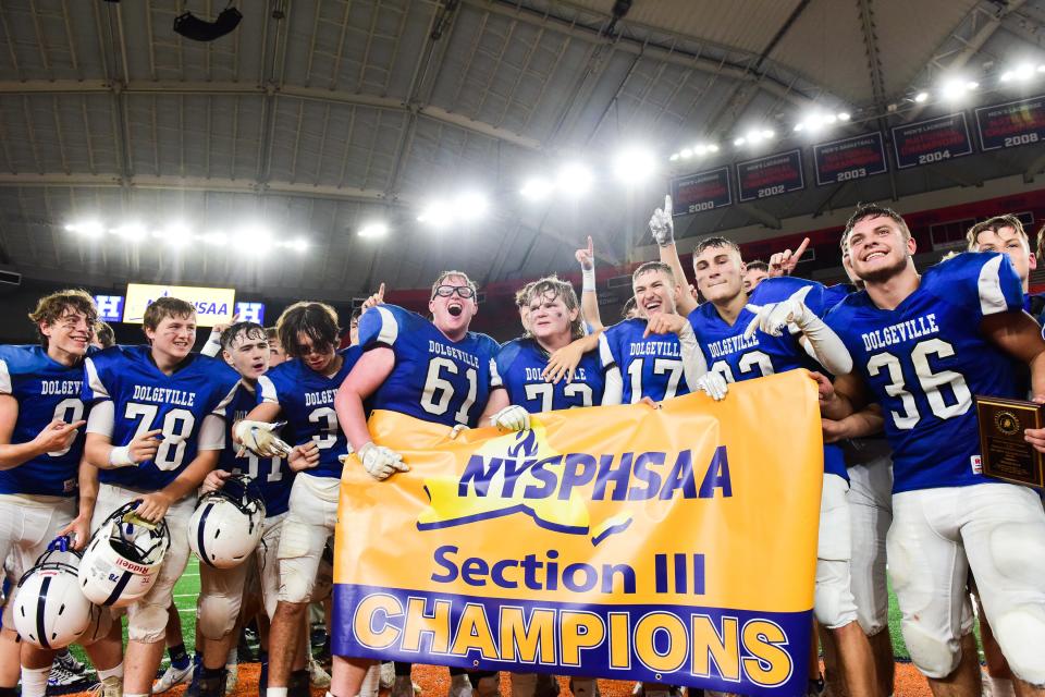 Dolgeville players celebrate after winning the Section III Class D championship game against Adirondack 20-6 on Friday, Nov. 12, 2021 at the Carrier Dome in Syracuse.