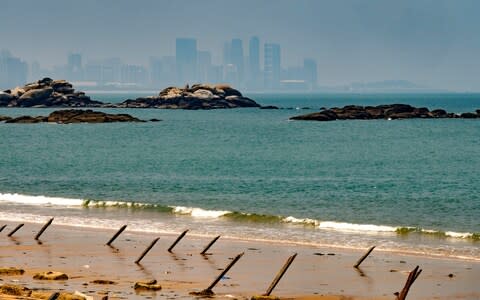 View over Xiamen City in Fujian province from Dadan Island's beach - Credit: Alberto Buzzola/LightRocket