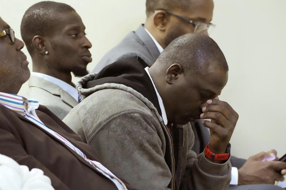 Eddie Terrell Parker, right, one of two victims of racially motivated torture by six former Mississippi law enforcement officers, with his friend Michael Corey Jenkins, reacts during their sentencing in state court for their roles in the 2023 assault, Wednesday, April 10, 2024, in Brandon, Miss. Rankin County Circuit Judge Steve Ratcliff gave the six former Mississippi law enforcement officers yearslong state sentences that were shorter than the amount of time in federal prison that they had already received. Time served for the state convictions will run concurrently, or at the same time, as the federal sentences, and the men will serve their time in federal penitentiaries. (AP Photo/Rogelio V. Solis)