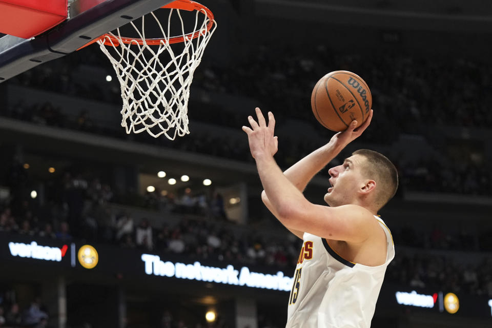 Denver Nuggets center Nikola Jokic (15) goes up for a shot against the Utah Jazz during the second quarter of an NBA basketball game Friday, Oct. 28, 2022, in Denver. (AP Photo/Jack Dempsey)