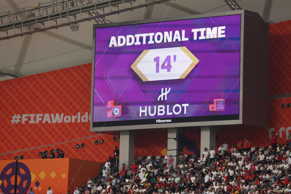 DOHA, QATAR - NOVEMBER 21: A board signifying 14 minutes of first half stoppage time is seen during the FIFA World Cup Qatar 2022 Group B match between England and IR Iran at Khalifa International Stadium on November 21, 2022 in Doha, Qatar. (Photo by Alex Livesey - Danehouse/Getty Images)