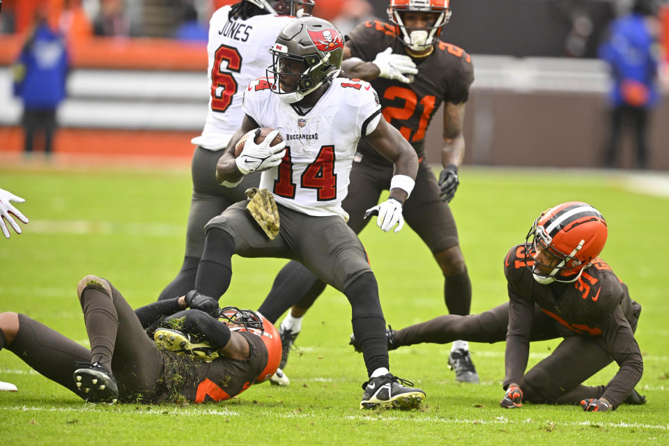 Tampa Bay Buccaneers wide receiver Chris Godwin (14) is tackled after making a catch during the first half of an NFL football game against the Cleveland Browns in Cleveland, Sunday, Nov. 27, 2022. (AP Photo/David Richard)