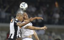 Nilton (R) of Cruzeiro jumps for the ball with Leonardo Silva of Atletico Mineiro during their Copa do Brasil final soccer match at Mineirao stadium in Belo Horizonte, in this November 26, 2014 file photo. REUTERS/Washington Alves/Files (BRAZIL - Tags: SPORT SOCCER TPX IMAGES OF THE DAY)