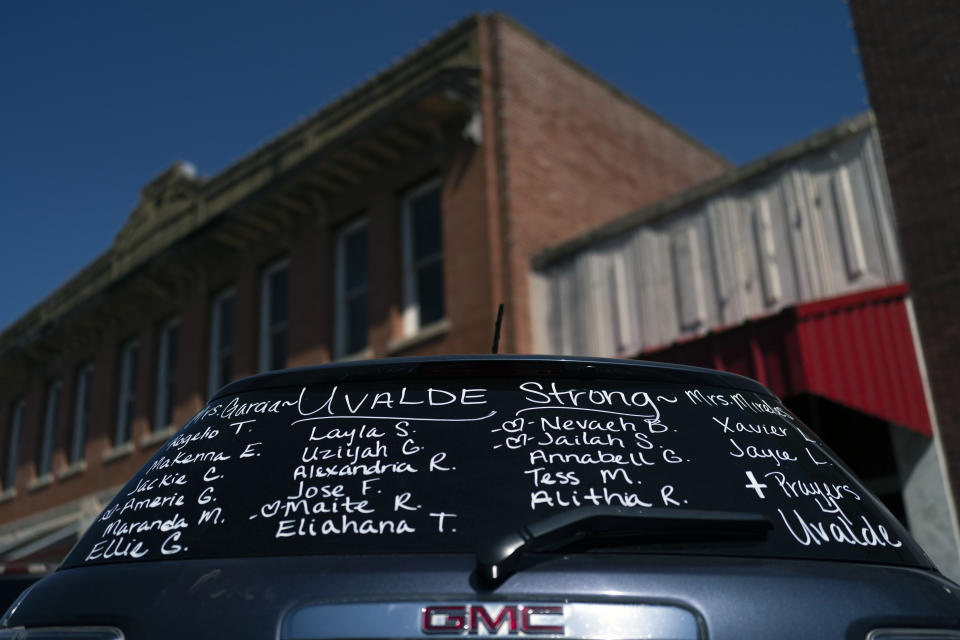 The names of the victims killed in last week's elementary school shooting are written on the back of an SUV near a memorial in Uvalde, Texas, Friday, June 3, 2022. It's hard to say exactly when some Texas educators began to feel like they were under siege, but the massacre of 19 students and two teachers at Robb Elementary School is only the latest, horrific episode in a string of events dating back years. (AP Photo/Jae C. Hong)