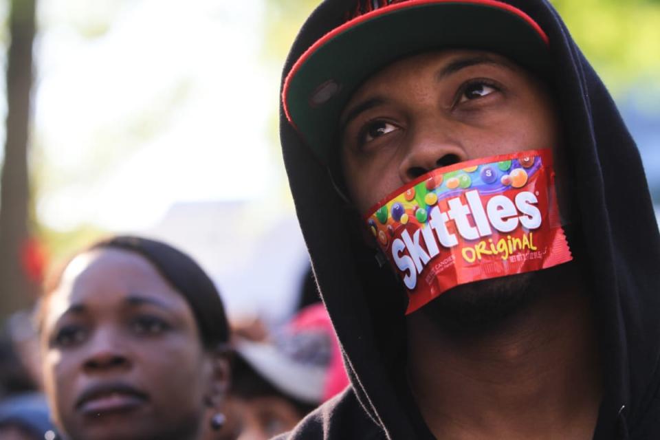 <div class="inline-image__caption"><p>College student Jajuan Kelley covers his mouth with a Skittles wrapper as he stands in a crowd of thousands rallying at the Georgia State Capitol in memory of slain Florida teenager Trayvon Martin on March 26, 2012 in Atlanta, Georgia. Protests have been nationwide in reaction to the death of Trayvon Martin, the Florida teenager whose shooting by a neighborhood watch captain has led to questions of the "Stand Your Ground" law in Florida and other states. </p></div> <div class="inline-image__credit">Jessica McGowan/Getty</div>