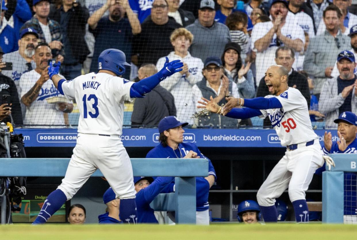 Mookie Betts throws sunflower seeds at Max Muncy after Muncy hit a grand slam in the first inning.