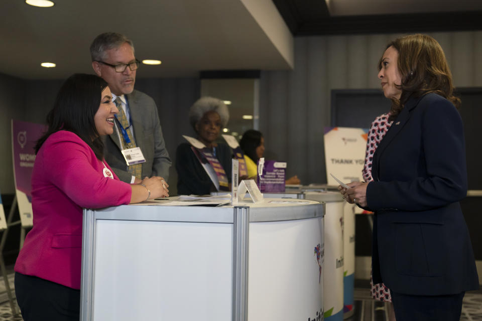 Vice President Kamala Harris, right, listens to Aida Saucedo from Mexico's National Women's Civic Association while touring an exhibit hall at the Summit of the Americas in Los Angeles, Monday, June 6, 2022. (AP Photo/Jae C. Hong)