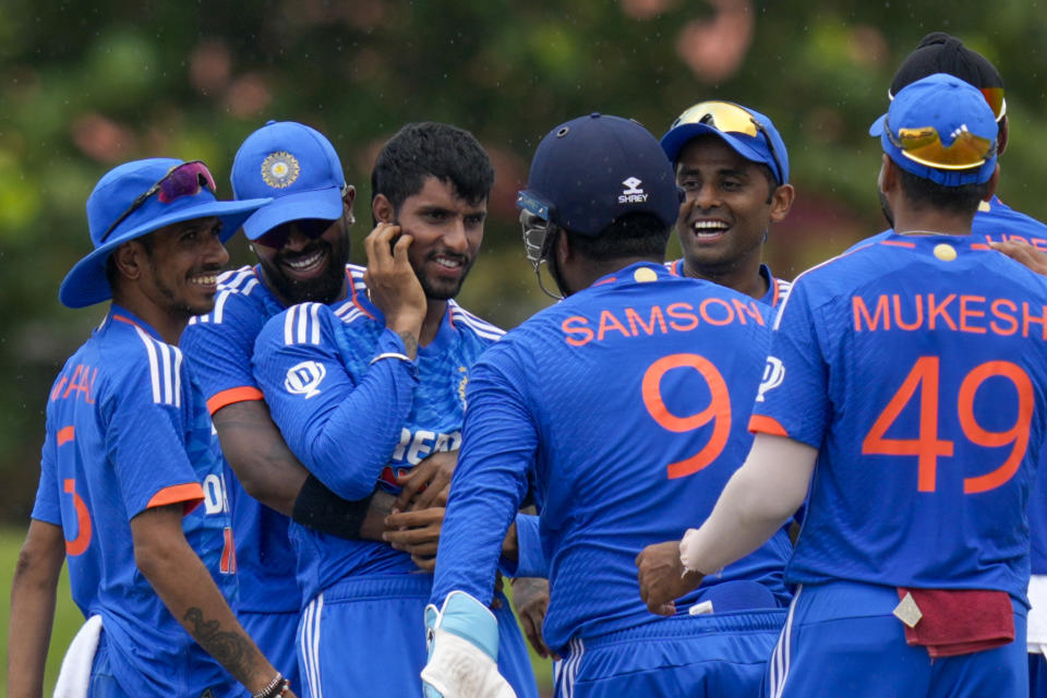 Teammates surround India's Tilak Varma after he dismissed West Indies' Nicholas Pooran during the fifth T20 cricket match at Central Broward Regional Park in Lauderhill, Fla, Sunday, Aug. 13, 2023. (AP Photo/Ramon Espinosa)