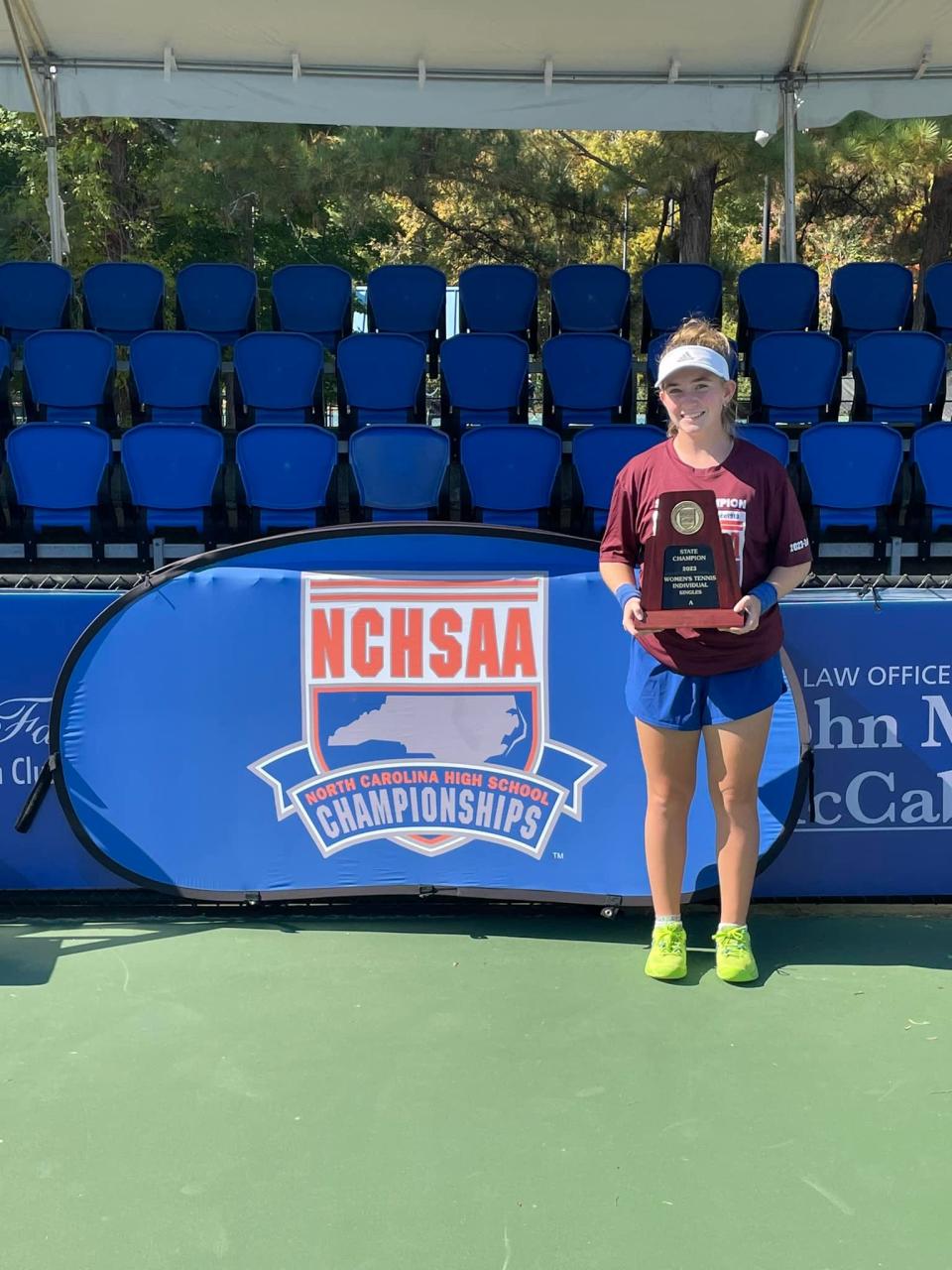 Highland Tech girls tennis player Madison Darnell holds up her state championship trophy won after claiming the 1A singles title on Oct. 28, 2023.