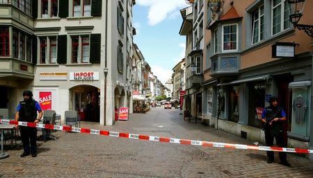 Swiss police officers stand at a crime scene in Schaffhausen, Switzerland July 24, 2017. REUTERS/Arnd Wiegmann