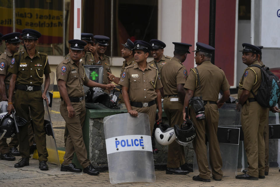 Police officers stand guard outside the official residence of the president in Colombo, Sri Lanka, Thursday, July 21, 2022. Sri Lanka's prime minister Ranil Wickremesinghe was elected president Wednesday by lawmakers who opted for a seasoned, veteran leader to lead the country out of economic collapse, despite widespread public opposition. (AP Photo/Rafiq Maqbool)