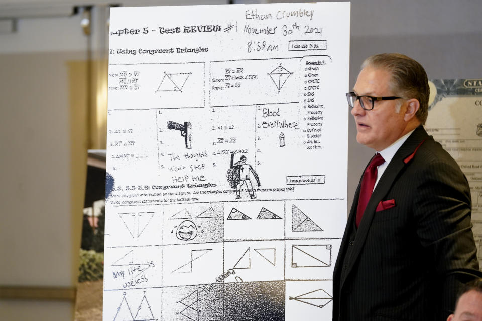 Attorney Ven Johnson shows a blowup of Ethan Crumbley's test review paper with notes and drawings during a news conference in Southfield, Mich., Thursday, Jan. 27, 2022. A new lawsuit alleging negligence by school officials and a Michigan school shooting suspect's parents was filed Thursday over the attack at Oxford High School that killed four students and wounded six other students and a teacher. (AP Photo/Paul Sancya)