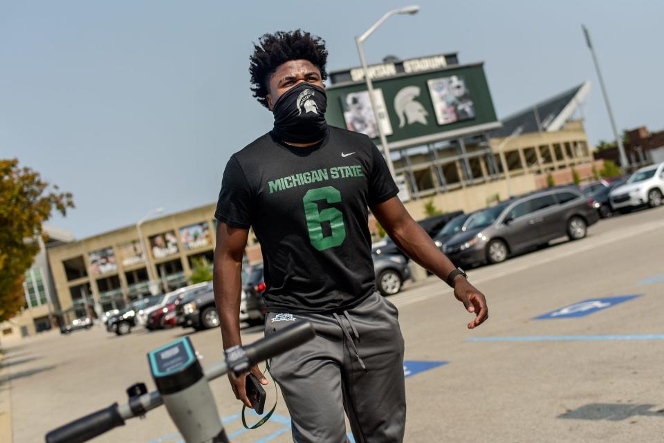 Michigan State football player Michael Dowell walks to the Skandalaris Football Center/Duffy Daugherty Football Building on Wednesday, Sept. 16, 2020, in East Lansing. On Dowell's shirt is the number his brother David wore during his time with the MSU football team.