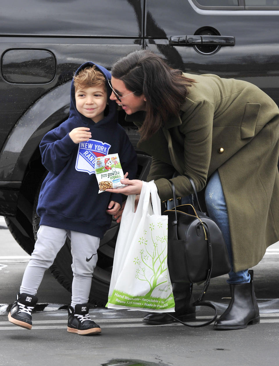 Jamie Lynn Sigler and son with a bag of Pure Growth Organic Snack Mix at a&nbsp;Walmart in Los Angeles.