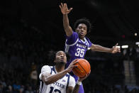 Butler guard Jayden Taylor (13) shoots under Kansas State forward Nae'Qwan Tomlin (35) in the first half of an NCAA college basketball game in Indianapolis, Wednesday, Nov. 30, 2022. (AP Photo/Michael Conroy)