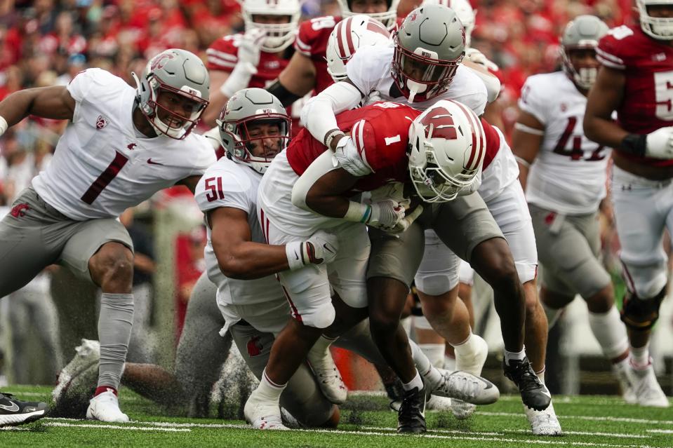 Wisconsin's Chez Mellusi (1) is stopped during the first half of an NCAA college football game against Washington StateSaturday, Sept. 10, 2022, in Madison, Wis. (AP Photo/Morry Gash)