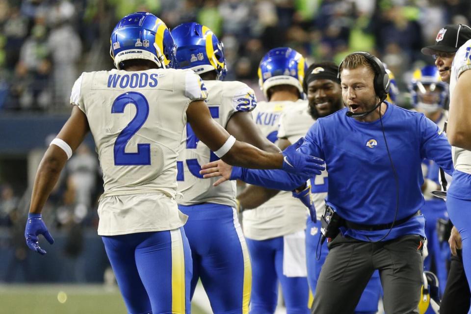 Los Angeles Rams head coach Sean McVay, right, greets Robert Woods.