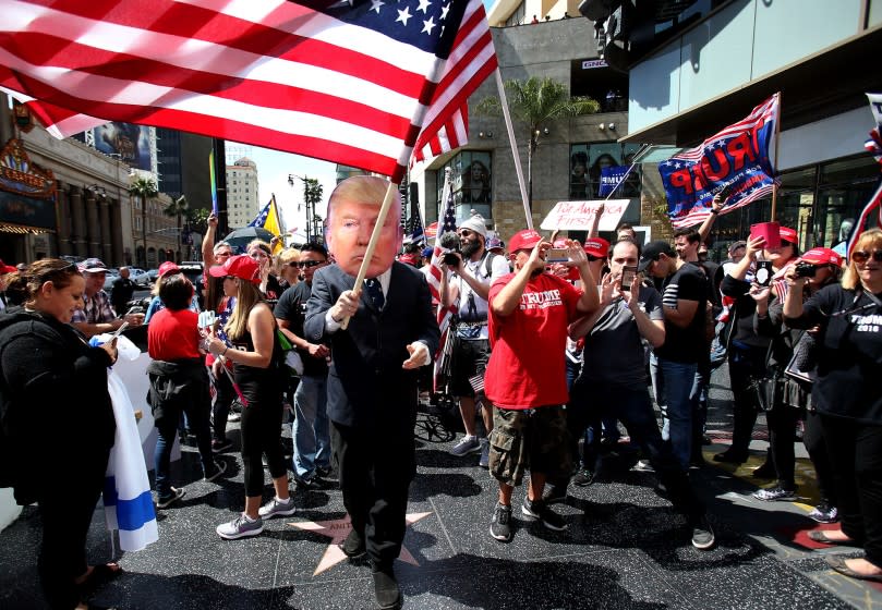 Trump supporters march in the Make America Great Again rally on Hollywood Boulevard.