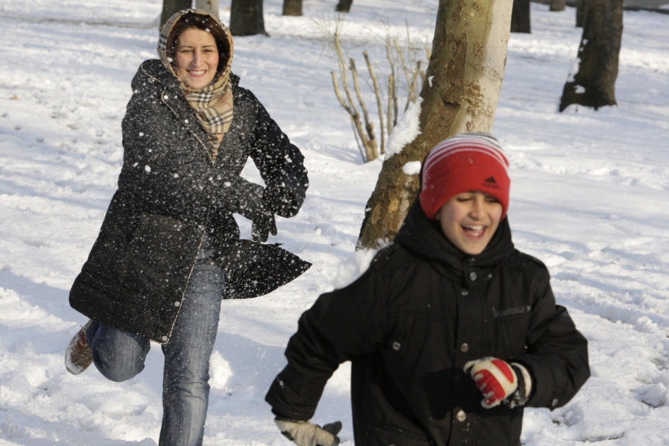 A mother and child engage in a snowball fight in Tehran, Iran, on Jan. 21, 2012.