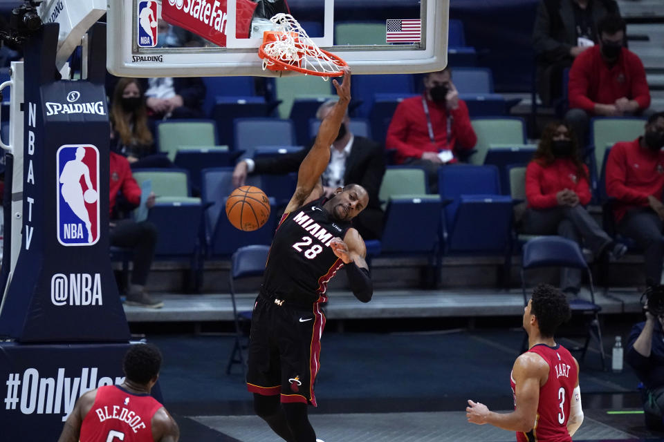 Miami Heat forward Andre Iguodala (28) dunks in front of New Orleans Pelicans guards Josh Hart (3) and Eric Bledsoe during the second half of an NBA basketball game in New Orleans, Thursday, March 4, 2021. (AP Photo/Gerald Herbert)