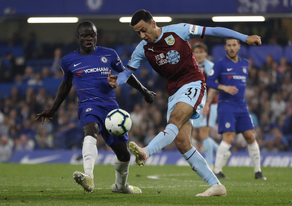 Chelsea's N'Golo Kante, left, competes for the ball with Burnley's Dwight McNeil during the English Premier League soccer match between Chelsea and Burnley at Stamford Bridge stadium in London, Monday, April 22, 2019. (AP Photo/Kirsty Wigglesworth)