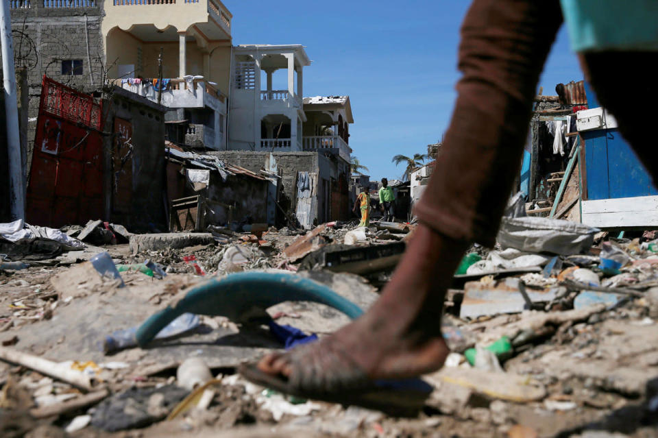 <p>People walk on a street filled with rubble after Hurricane Matthew passes in Jeremie, Haiti, October 8, 2016. (REUTERS/Carlos Garcia Rawlins)</p>