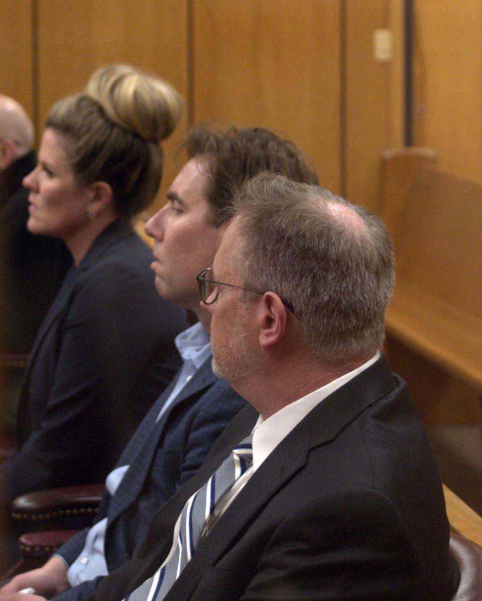 Anthony Patterson, center, sits flanked by his attorneys in 78th District Court in May 2023. Judge Meredith Kennedy agreed to move his trial on sex charges involving children to October because of new allegations against the former auto dealer.