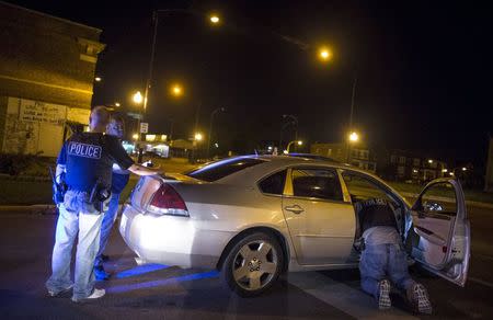 Cook County Sheriff police officers question a man and search his car during a street stop in the Austin neighborhood in Chicago, Illinois, United States, September 9, 2015. REUTERS/Jim Young