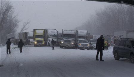 Trucks and passenger vehicles block eastbound Interstate 94 following a massive crash that killed three people and injured about 20 near Michigan City, Indiana January 23, 2014. REUTERS/Indiana State Police/Handout