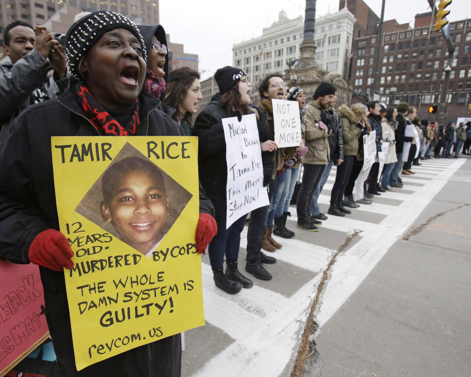 FILE - In this Nov. 25, 2014 file photo, demonstrators block Public Square in Cleveland, during a protest over the police shooting of 12-year-old Tamir Rice. Cleveland Police did not check on Timothy Loehmann’s history before hiring him. And Ohio law required a felony before an officer would lose his badge. So it was Loehmann who responded to the park where Tamir Rice was playing with what turned out to be a toy gun. Loehmann shot him dead. (AP Photo/Tony Dejak, File)