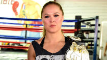 <p>Rousey poses with her title belt at the Glendale Fighting Club in California.</p>